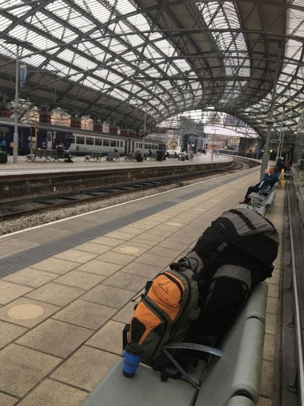 Rucksacks on a bench at a train stain awaiting a train to their new home